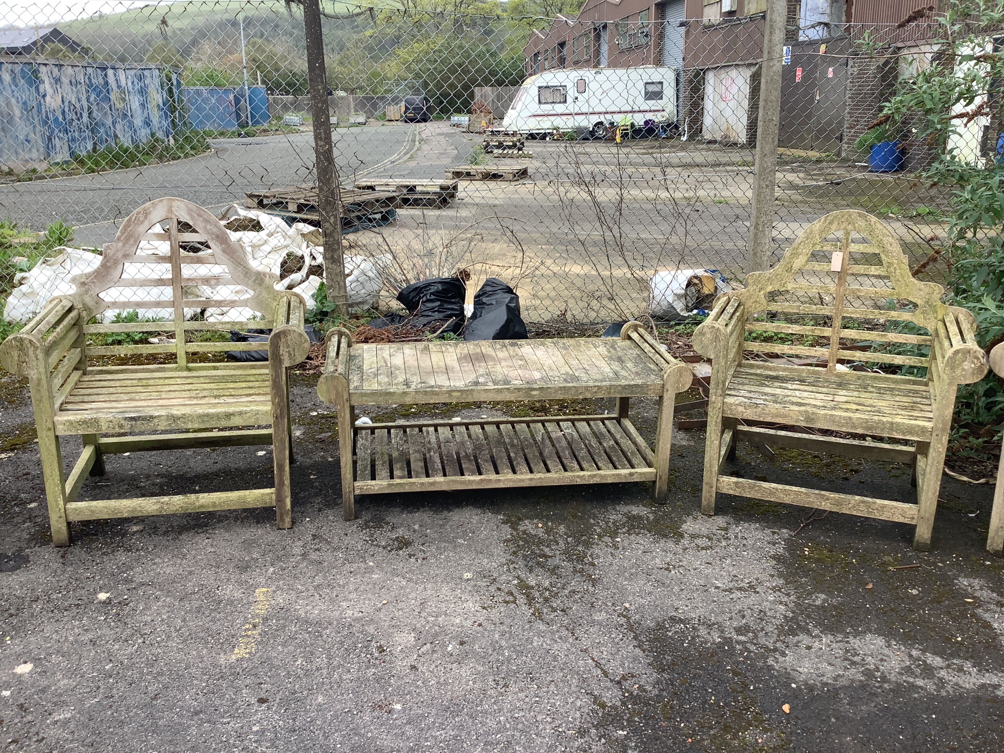 A pair of weathered teak Lutyens style garden armchairs, width 91cm, depth 56cm, height 107cm together with a similar rectangular coffee table
